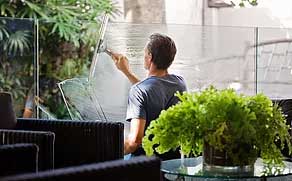 A man washing a glass window in Vancouver